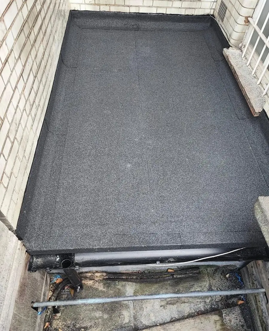 New torch-on felt flat roof with insulation and a lead edge detail